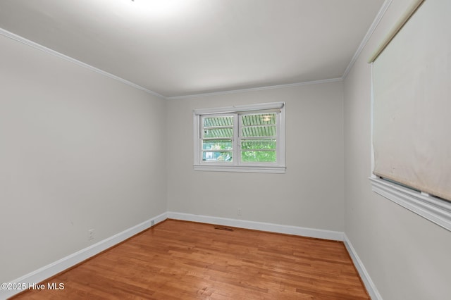 1704 Charlotte Ave, Kinston, NC 28501 - spare room with light wood-type flooring, baseboards, and crown molding