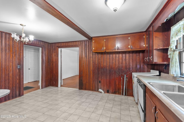 1704 Charlotte Ave, Kinston, NC 28501 - kitchen with light countertops, a chandelier, wooden walls, a sink, and pendant lighting