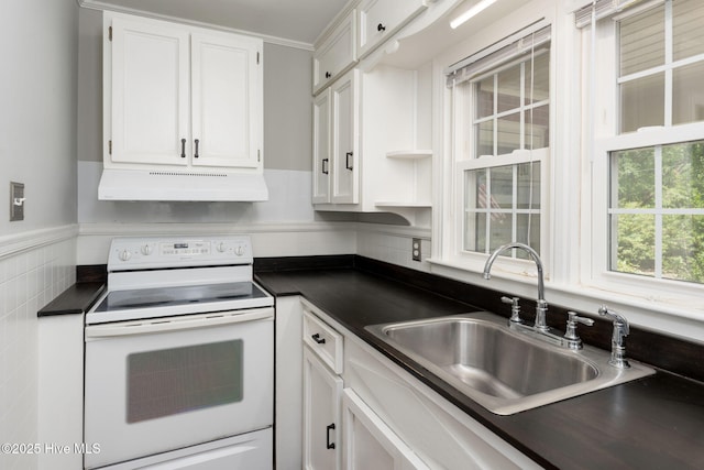 211 Spruce Cir, Wilmington, NC 28403 - kitchen with electric stove, under cabinet range hood, dark countertops, a sink, and white cabinetry
