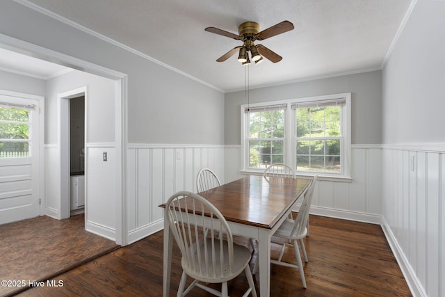211 Spruce Cir, Wilmington, NC 28403 - dining room with a wainscoted wall, a ceiling fan, dark wood-type flooring, healthy amount of natural light, and crown molding