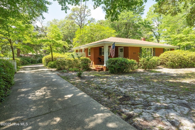 211 Spruce Cir, Wilmington, NC 28403 - single story home with a porch, a chimney, and brick siding
