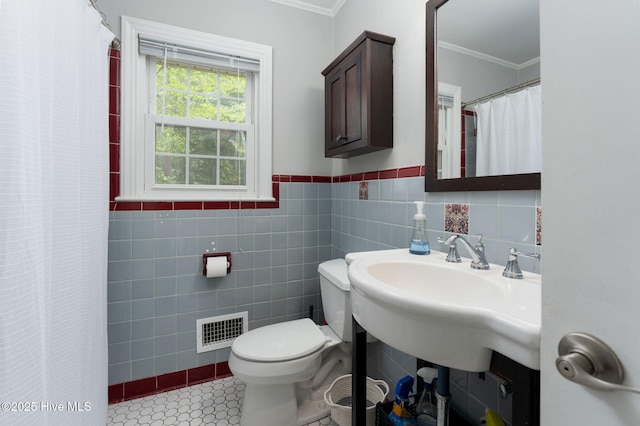 211 Spruce Cir, Wilmington, NC 28403 - full bathroom featuring ornamental molding, toilet, a shower with curtain, tile walls, and a wainscoted wall