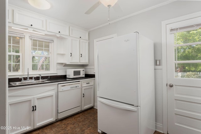 211 Spruce Cir, Wilmington, NC 28403 - kitchen featuring white appliances, a sink, dark countertops, white cabinetry, and ceiling fan