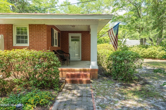 211 Spruce Cir, Wilmington, NC 28403 - entrance to property featuring a porch and brick siding