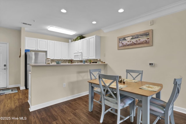 395 S Crow Creek Dr Unit 2306, Calabash, NC 28467 - dining space with dark wood finished floors, ornamental molding, recessed lighting, and baseboards