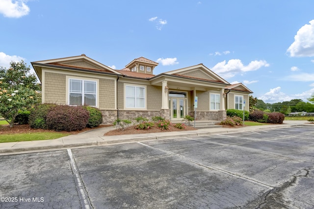 395 S Crow Creek Dr Unit 2306, Calabash, NC 28467 - view of front of home with stone siding, french doors, and uncovered parking