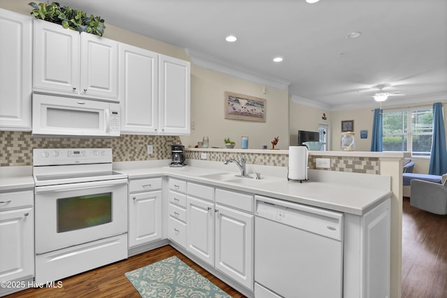 395 S Crow Creek Dr Unit 2306, Calabash, NC 28467 - kitchen with white appliances, a peninsula, crown molding, backsplash, and white cabinetry