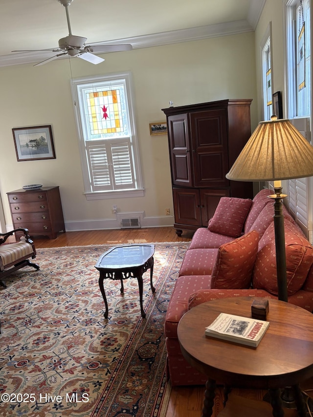 215 W Queen St, Edenton, NC 27932 - living room with baseboards, wood finished floors, ornamental molding, and a ceiling fan