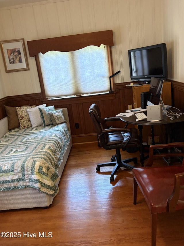 215 W Queen St, Edenton, NC 27932 - bedroom with multiple windows, wood finished floors, a desk, and wood walls