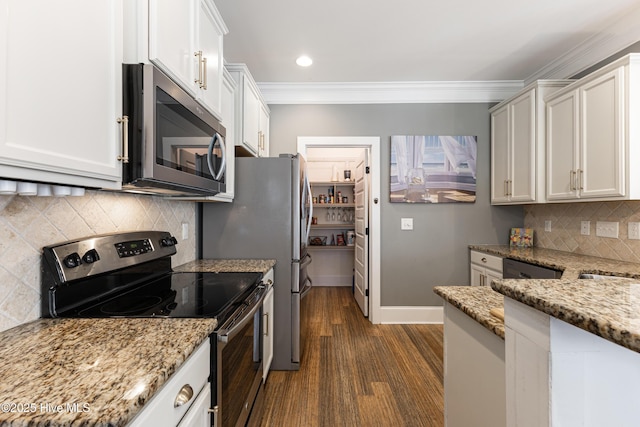 157 Heritage Way, Hampstead, NC 28443 - kitchen featuring appliances with stainless steel finishes, light stone countertops, decorative backsplash, crown molding, and white cabinetry