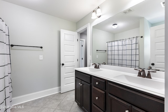 157 Heritage Way, Hampstead, NC 28443 - full bathroom with tile patterned flooring, double vanity, and baseboards