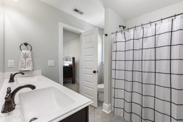 157 Heritage Way, Hampstead, NC 28443 - ensuite bathroom featuring toilet, vanity, and tile patterned flooring
