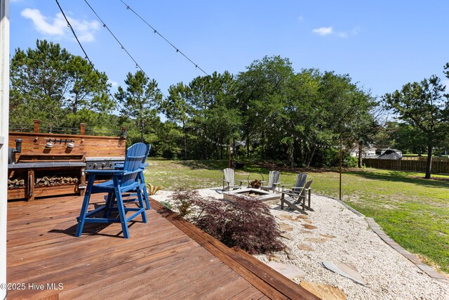 157 Heritage Way, Hampstead, NC 28443 - wooden deck featuring an outdoor fire pit and view of scattered trees