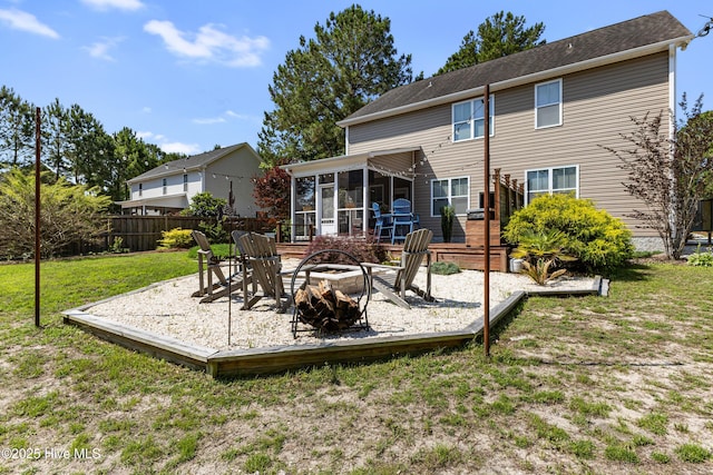 157 Heritage Way, Hampstead, NC 28443 - back of property featuring a sunroom, an outdoor fire pit, and a wooden deck