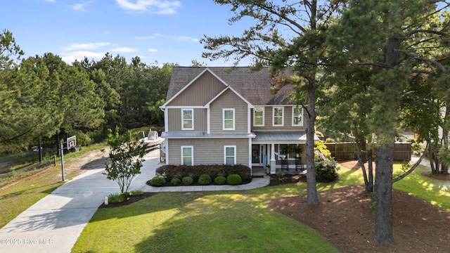 157 Heritage Way, Hampstead, NC 28443 - view of front of home with a porch, concrete driveway, a front yard, and a shingled roof
