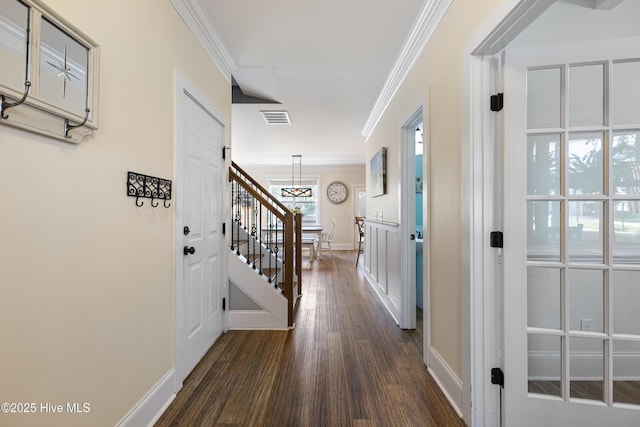 157 Heritage Way, Hampstead, NC 28443 - hallway with crown molding, dark wood-style floors, a chandelier, baseboards, and stairs