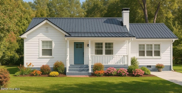 106 Forest Dr, Riegelwood, NC 28456 - view of front of home with covered porch, a chimney, crawl space, and a front lawn