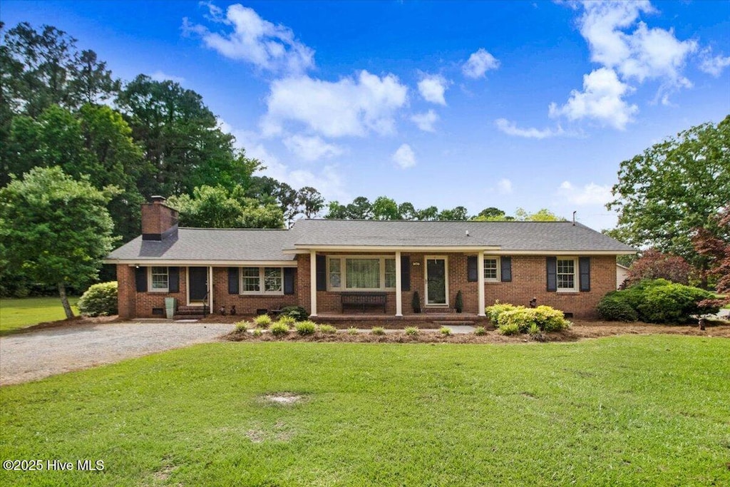 1436 Firetower Rd, Selma, NC 27576 - ranch-style home featuring brick siding, a front yard, a chimney, and driveway