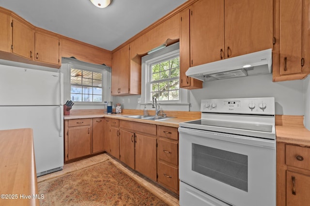 410 Craven St, Bath, NC 27808 - kitchen with white appliances, under cabinet range hood, a sink, light countertops, and light tile patterned floors