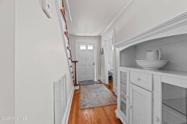 410 Craven St, Bath, NC 27808 - entrance foyer with light wood-type flooring, crown molding, and baseboards