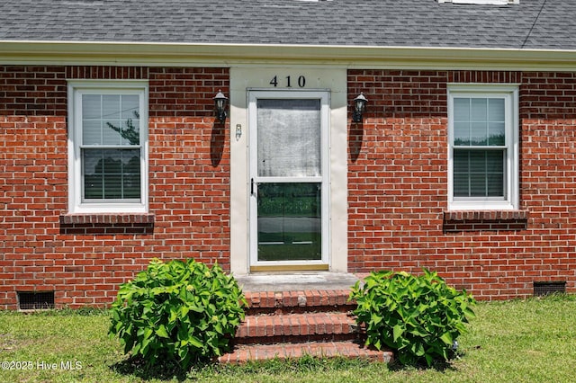 410 Craven St, Bath, NC 27808 - view of exterior entry with roof with shingles, crawl space, and brick siding