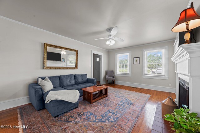 410 Craven St, Bath, NC 27808 - living area featuring crown molding, baseboards, wood finished floors, a ceiling fan, and a fireplace with flush hearth