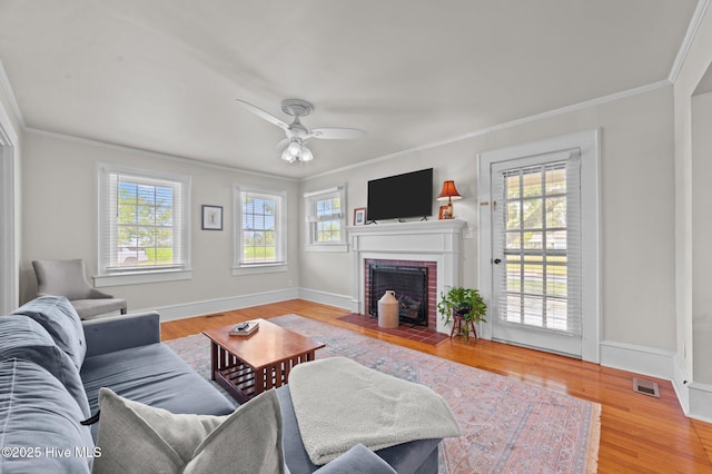 410 Craven St, Bath, NC 27808 - living area featuring ornamental molding, a fireplace, a ceiling fan, wood finished floors, and baseboards