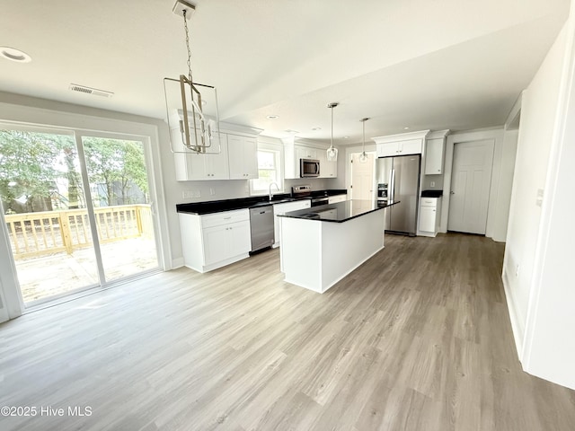 155 Launch Landing Rd, Moyock, NC 27958 - kitchen featuring stainless steel appliances, light wood-style flooring, white cabinets, dark countertops, and recessed lighting