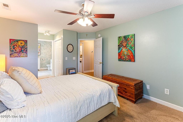 2 Beryl Cir, Pinehurst, NC 28374 - bedroom featuring baseboards, light carpet, ensuite bathroom, ceiling fan, and a closet