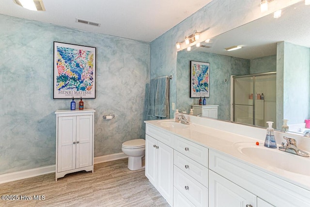 2 Beryl Cir, Pinehurst, NC 28374 - full bath with wood finished floors, a shower stall, toilet, double vanity, and baseboards