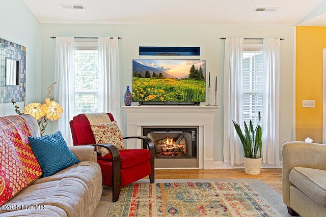 2 Beryl Cir, Pinehurst, NC 28374 - living room with wood finished floors, a glass covered fireplace, and healthy amount of natural light