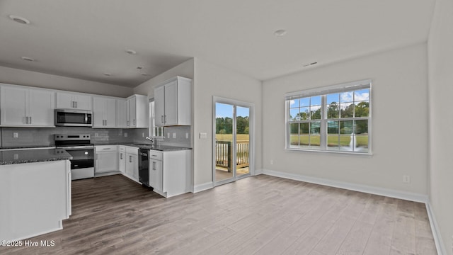 205 Lake Tyler Dr, New Bern, NC 28560 - kitchen featuring stainless steel appliances, wood finished floors, plenty of natural light, and white cabinetry