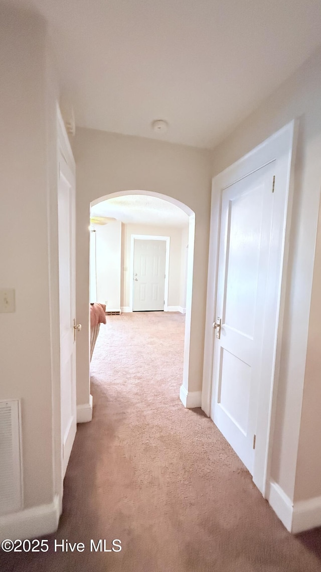 308 Terry St, Hamlet, NC 28345 - hallway with arched walkways, carpet floors, and baseboards