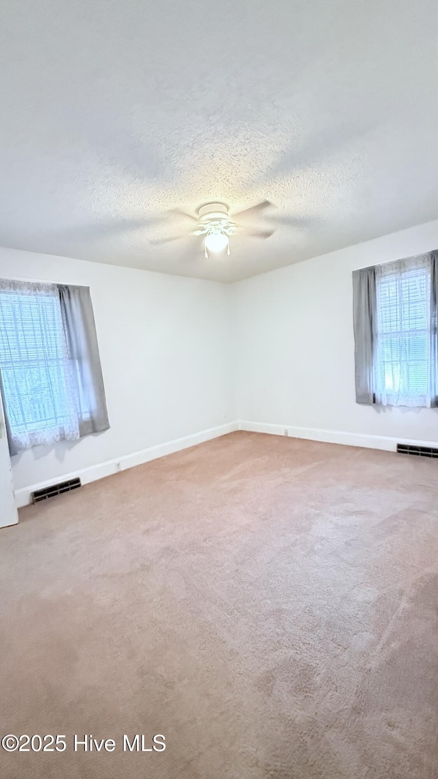 308 Terry St, Hamlet, NC 28345 - unfurnished room featuring ceiling fan, a textured ceiling, carpet, and baseboards