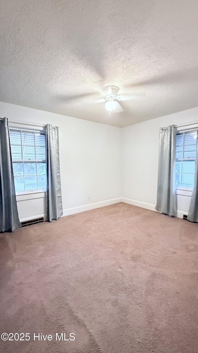 308 Terry St, Hamlet, NC 28345 - spare room with a textured ceiling, carpet floors, a ceiling fan, and baseboards