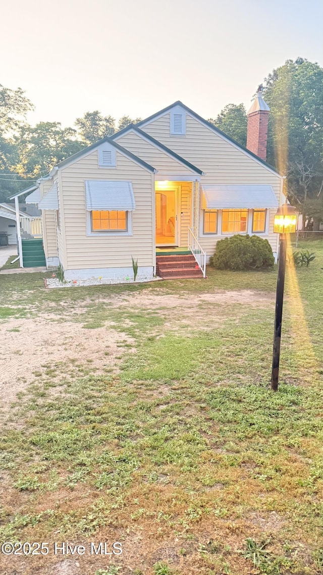 308 Terry St, Hamlet, NC 28345 - bungalow-style home with a front yard and a chimney