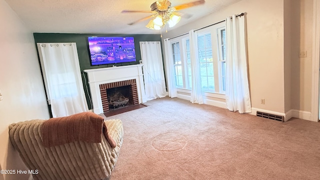 308 Terry St, Hamlet, NC 28345 - living room with a ceiling fan, a fireplace, carpet floors, baseboards, and a textured ceiling