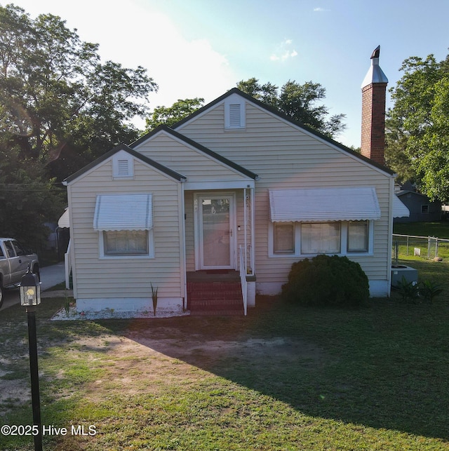 308 Terry St, Hamlet, NC 28345 - view of front of house featuring central air condition unit, a chimney, and entry steps