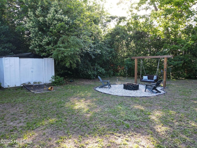 308 Terry St, Hamlet, NC 28345 - view of green lawn with an outdoor fire pit and a patio