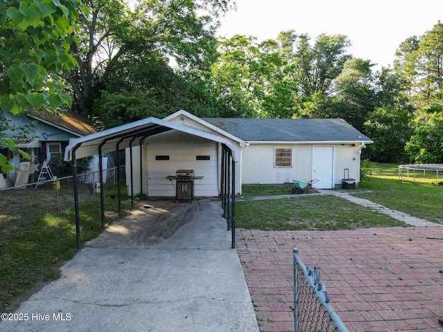 308 Terry St, Hamlet, NC 28345 - view of front of house featuring a trampoline, a garage, and driveway