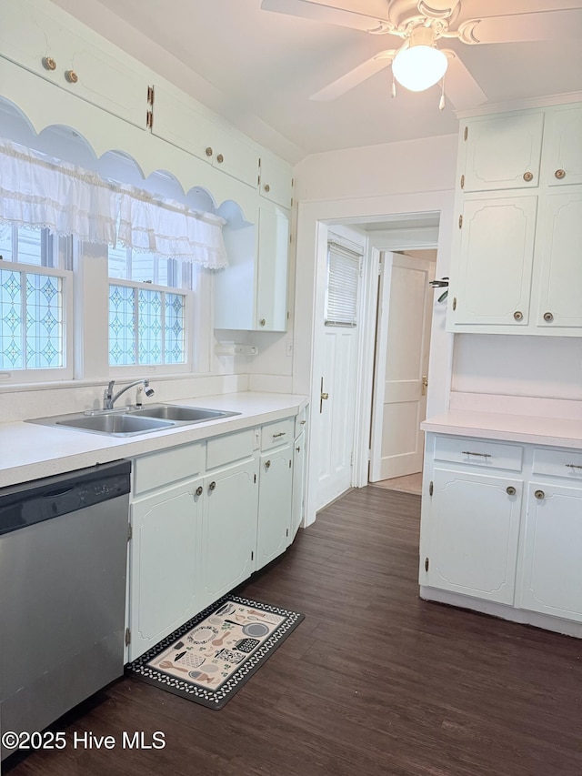308 Terry St, Hamlet, NC 28345 - kitchen featuring stainless steel dishwasher, a sink, dark wood finished floors, white cabinets, and light countertops