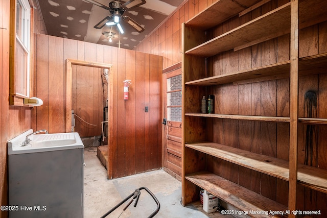 1363 Robert Everett Rd, Robersonville, NC 27871 - interior space featuring wooden walls, a ceiling fan, concrete floors, and a sink