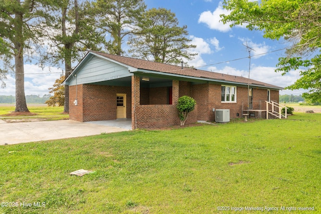 1363 Robert Everett Rd, Robersonville, NC 27871 - view of side of home featuring central air condition unit, driveway, a yard, a carport, and brick siding
