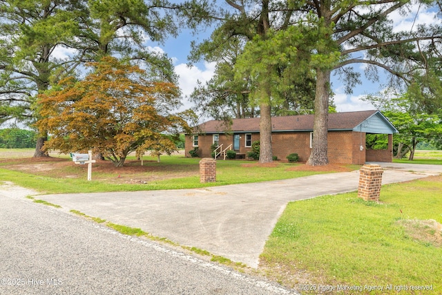 1363 Robert Everett Rd, Robersonville, NC 27871 - view of front of home featuring driveway, a front lawn, brick siding, and a carport
