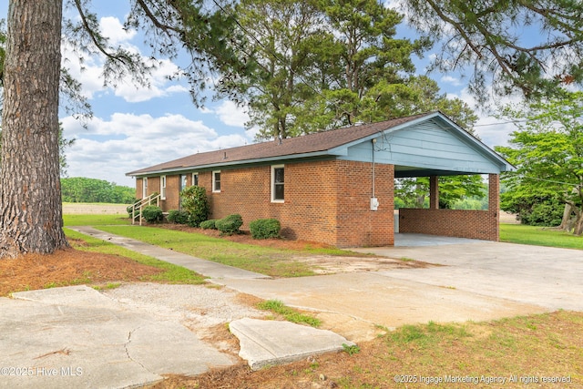 1363 Robert Everett Rd, Robersonville, NC 27871 - view of side of property featuring driveway, brick siding, a carport, and a yard