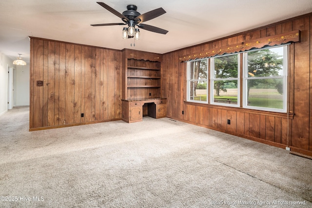 1363 Robert Everett Rd, Robersonville, NC 27871 - unfurnished living room with wood walls, light carpet, a ceiling fan, and baseboards