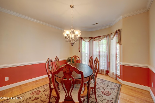 4029 Berberis Way, Wilmington, NC 28412 - dining space with a chandelier, light wood finished floors, baseboards, and ornamental molding