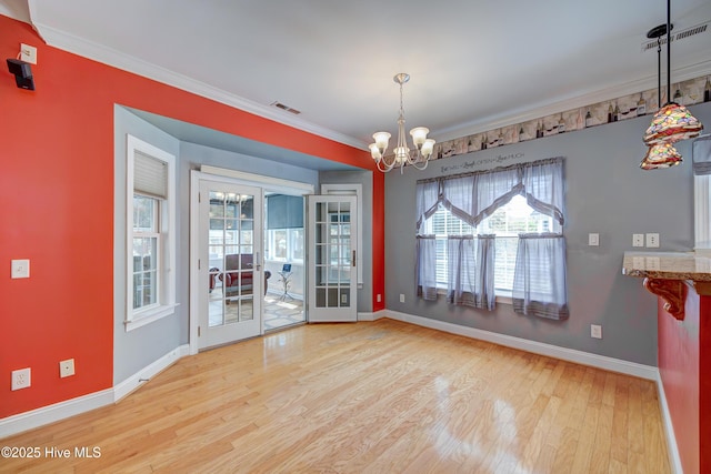 4029 Berberis Way, Wilmington, NC 28412 - unfurnished dining area with wood finished floors, healthy amount of natural light, a chandelier, baseboards, and ornamental molding