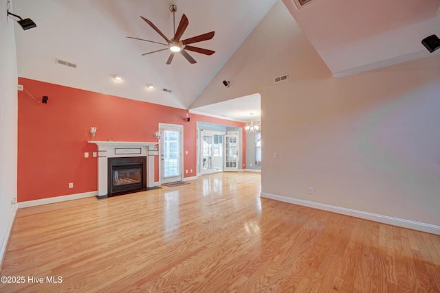 4029 Berberis Way, Wilmington, NC 28412 - unfurnished living room featuring a ceiling fan, light wood-style flooring, a glass covered fireplace, baseboards, and high vaulted ceiling
