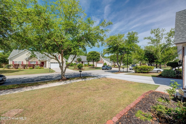 4029 Berberis Way, Wilmington, NC 28412 - view of green lawn featuring curved driveway and a residential view